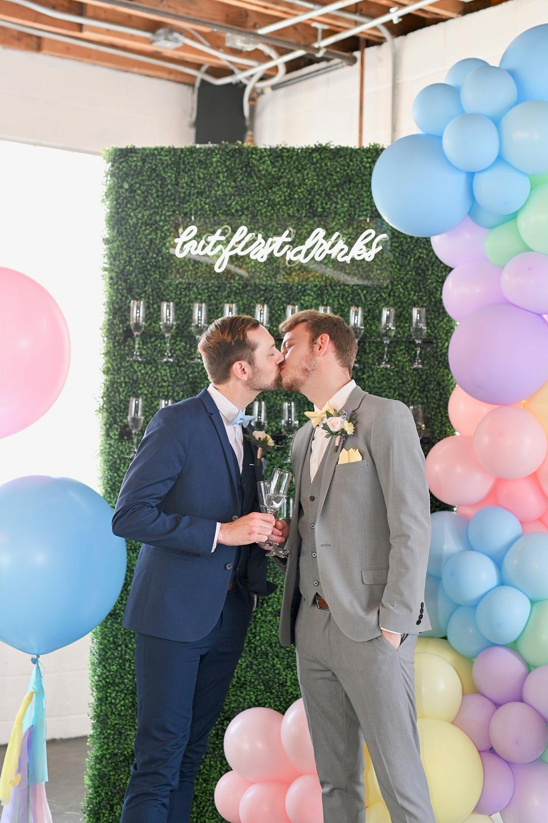 Grooms Kissing
