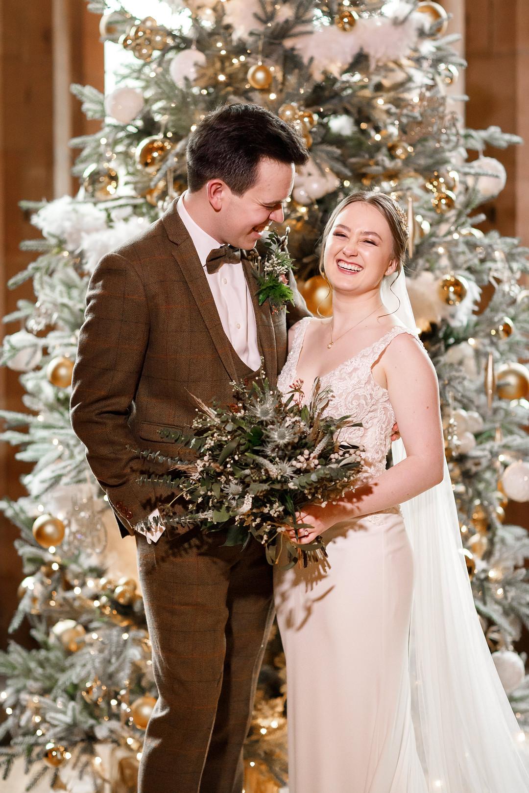 Bride and Groom by a Christmas Tree