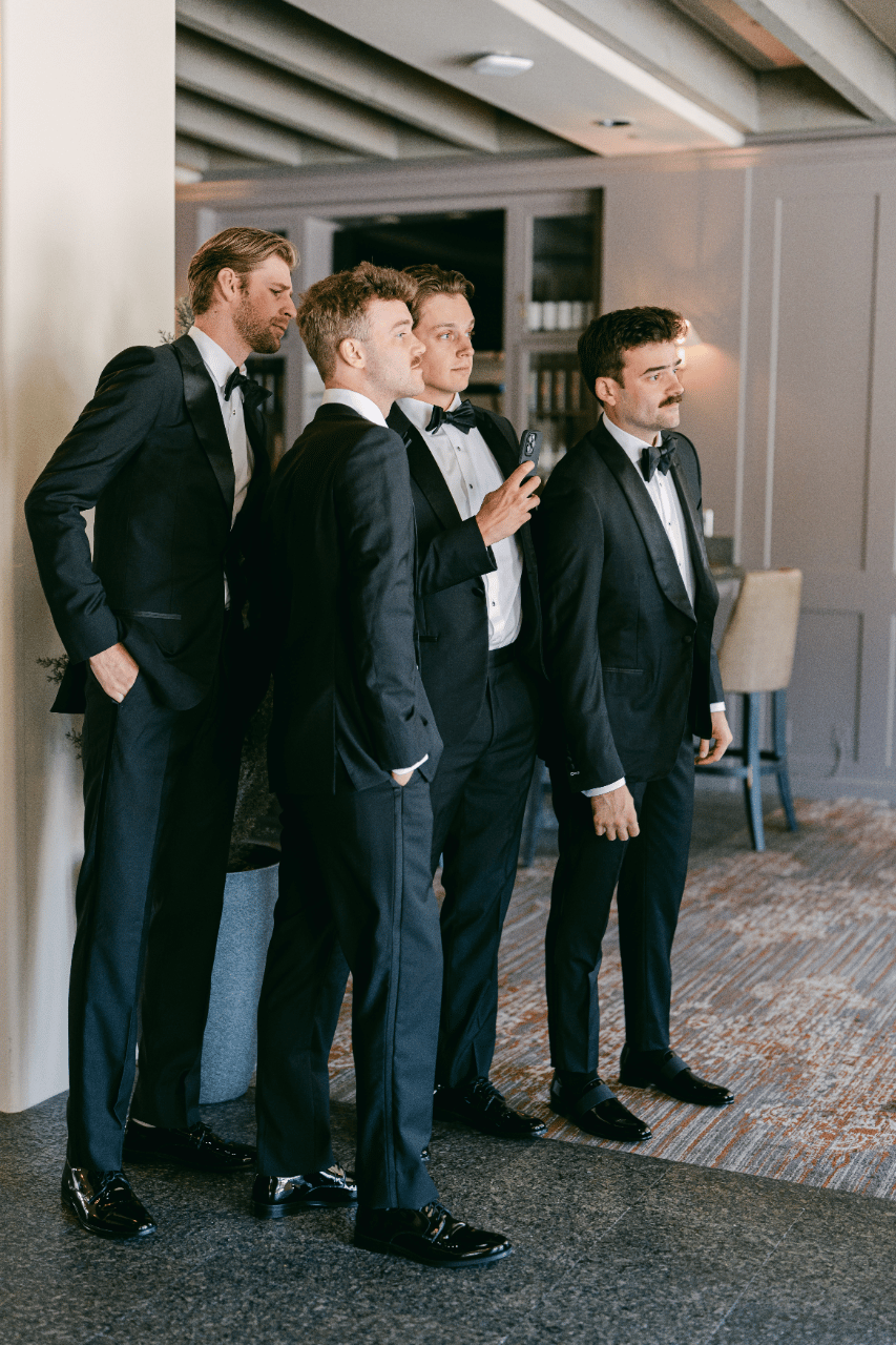 The groomsmen's help the groom seank a peek of his beautiful bride.