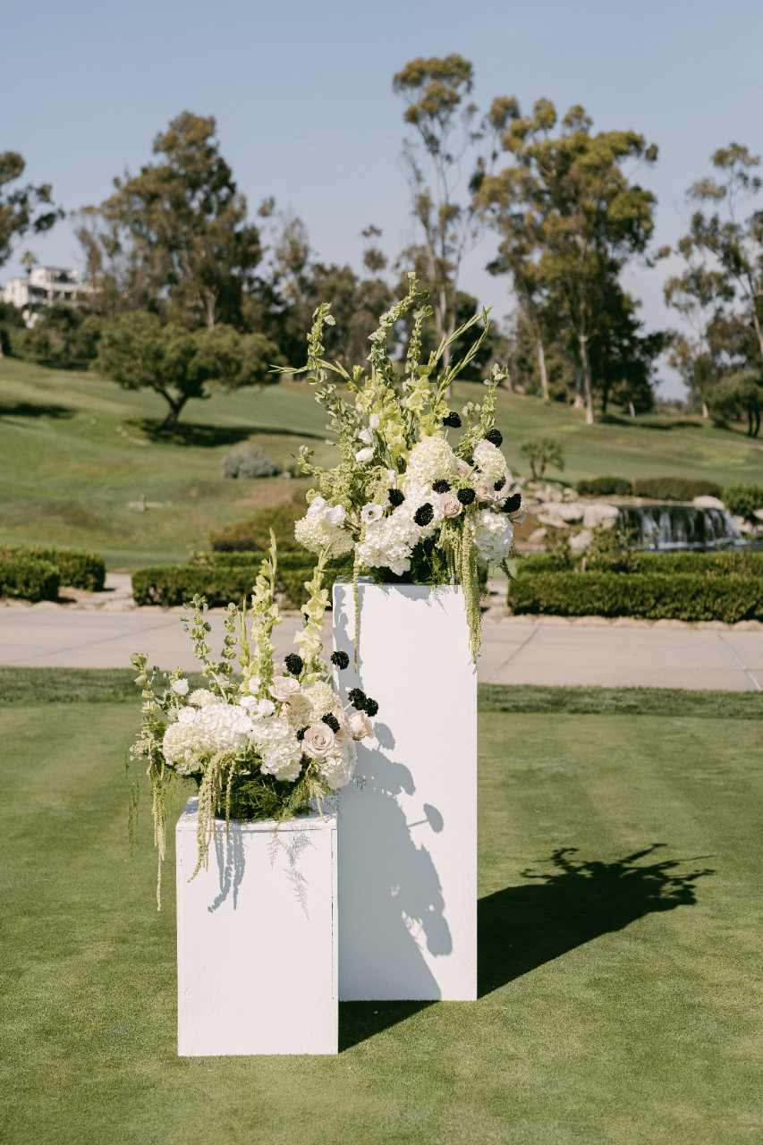 Wooden Columns With Wildly Romantic Flowers frame the ceremony site.