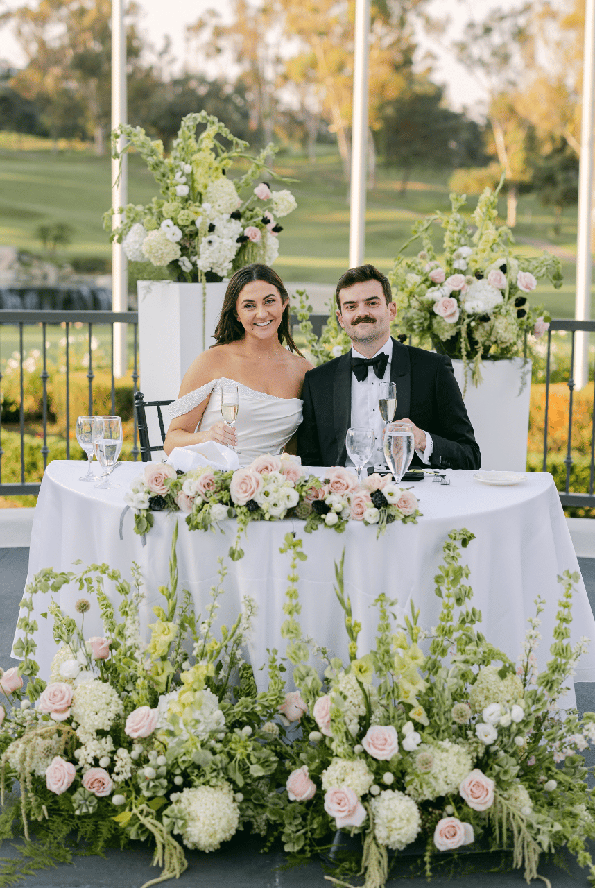Ceremony Florals repurposed to the sweetheart Table. The Couple surrounded in flowers for their first meal as Husband and Wife.