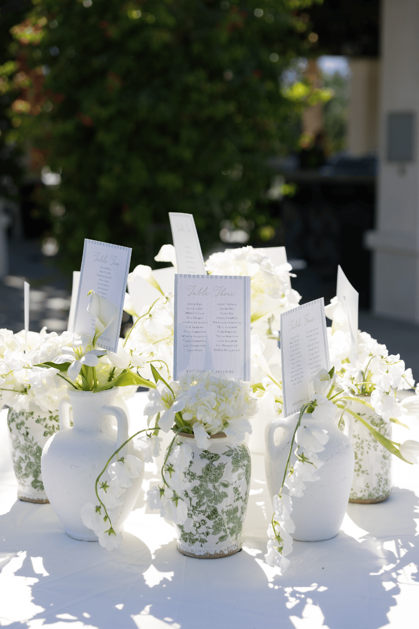 Escort display styled with white florals and soft textures.