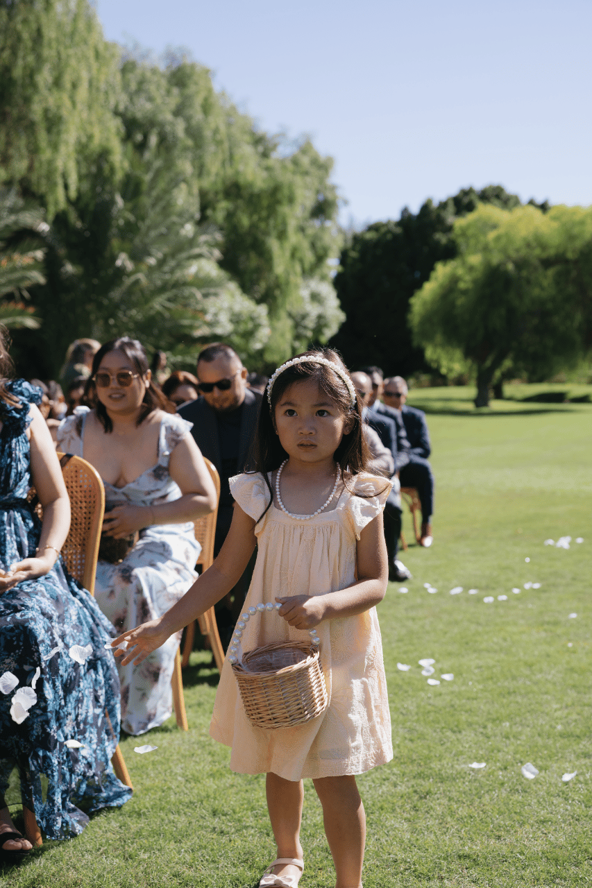 Petals scattered along the aisle in soft sunlight.