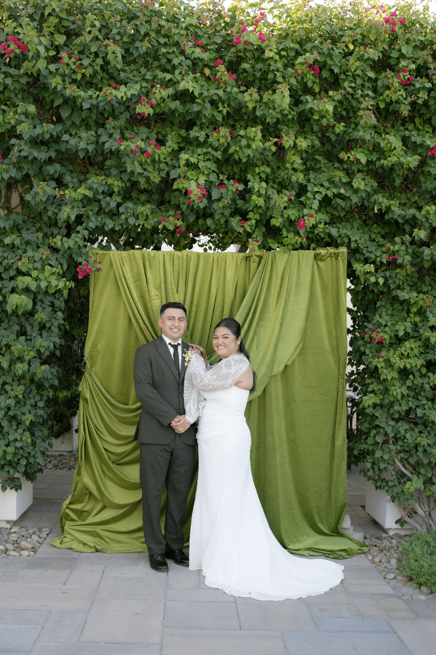 A classic portrait framed by layered greenery.