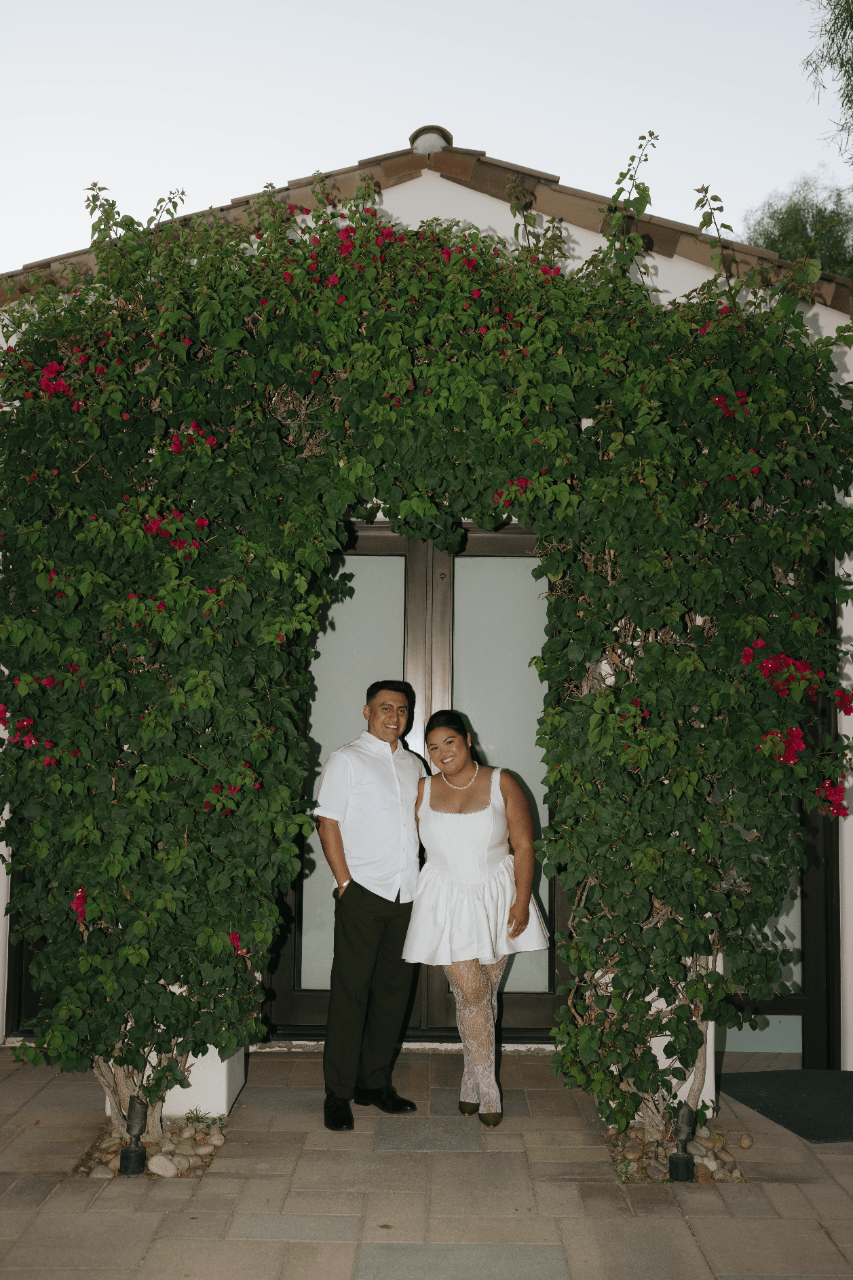A doorway framed in florals and greenery.