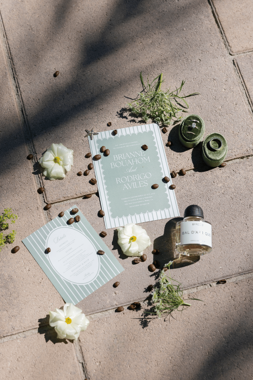 The invitation suite styled with organic textures and soft neutral details.